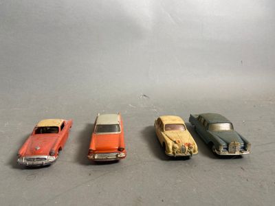 several toy cars are lined up in a row on a gray surface