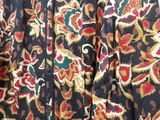 a close up of a jacket on a hanger on a wall