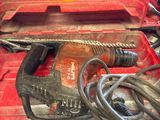 a red tool box with a hammer and a cord