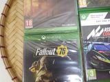 three xbox games sitting on top of a wooden tray on a table