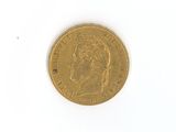 a gold coin on a white surface with a white background
