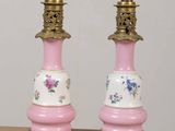 two pink and white vases sitting on a table