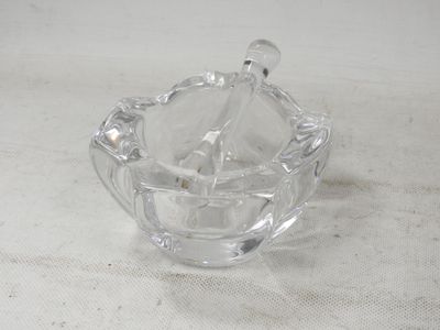 a clear glass bowl with a spoon inside of it