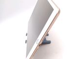 a tablet that is sitting on a stand on a table