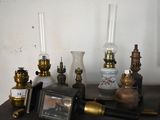 many different types of antique lamps on a table