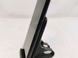 a cell phone that is on a stand on the table