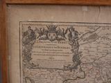 a picture of an old map in a wooden frame