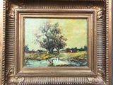une peinture à l'huile représentant un arbre au bord d'une rivière, dans un cadre doré