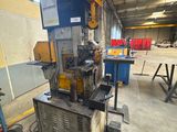 a large machine is sitting in a warehouse with other machines in the background