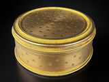 an image of a gold box on a black surface