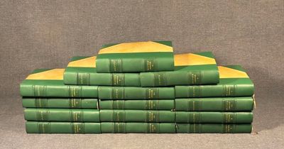 many green books stacked on top of each other