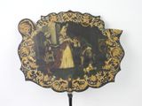 a black and gold fan with a painting on it