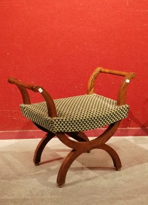a small wooden bench with a patterned seat on it