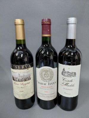 trois bouteilles de vin sont alignées sur une surface grise