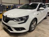 the white car is parked in a garage with other cars