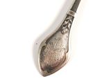 pair of silver spoons on a white surface with a white background