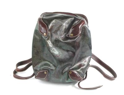 a green bag with a brown handle on a white background