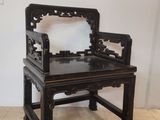 une chaise noire sur laquelle est posé un miroir