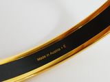 an image of a close up of a gold plate with a black stripe