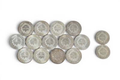 several coins are arranged in a row on a white surface