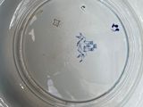 a white plate with a blue design on it