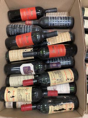 bottles of wine in a cardboard box sitting on a table