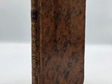 an old book sitting on top of a white table