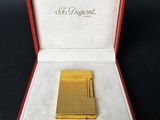 an image of a gold plated cigarette lighter in a red case