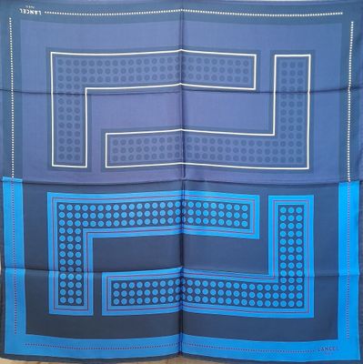 a blue and black scarf with a square design on it