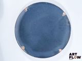 a blue plate with a hole in the middle of it