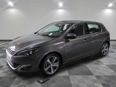 the grey car is parked in the garage on the checkered floor
