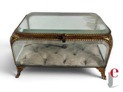 a glass box with a cushion on top of it