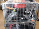 a metal cage filled with assorted items inside of a building