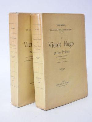 two books sitting on top of each other on a white surface