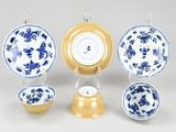 a group of blue and white plates and bowls on a table