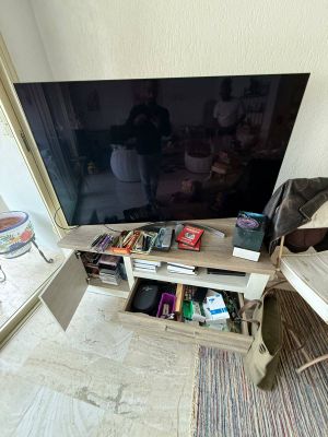 a flat screen tv sitting on a stand in a living room