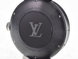 a close up of a watch on a white surface
