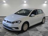 the white volkswagen golf is parked in a room with a checkered floor