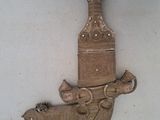 a wooden wall hanging with a clock and a bird on it