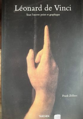 the cover of a book on a wooden table with a hand reaching for something