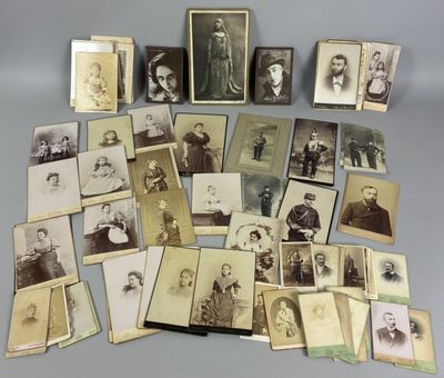 an assortment of old photographs of men and women are displayed on a table