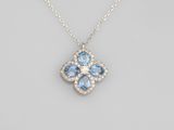 a blue topaz and diamond flower pendant on a chain