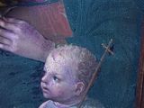 a painting of a baby holding a stick in a wooden frame