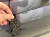 a person that is measuring the height of a car