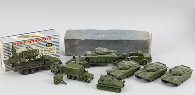 Des petits véhicules militaires sont alignés devant une boîte