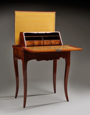 an antique writing desk with a wooden top and drawers