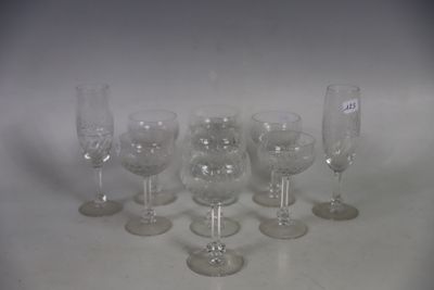 several empty wine glasses are lined up on a white surface