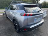 the rear end of a silver suv parked in a parking lot