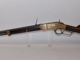 an old gun on display on a white surface
