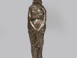 une figurine en bronze représentant une femme coiffée d'un chapeau